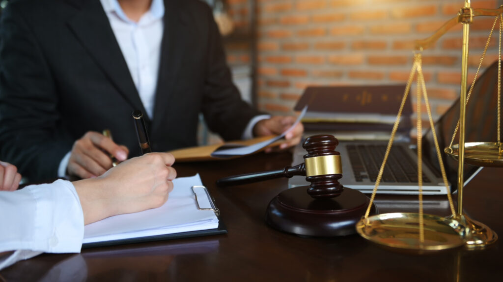 business people and lawyers discussing contract papers sitting a